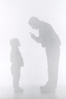 Silhouette of a father verbally correcting his son